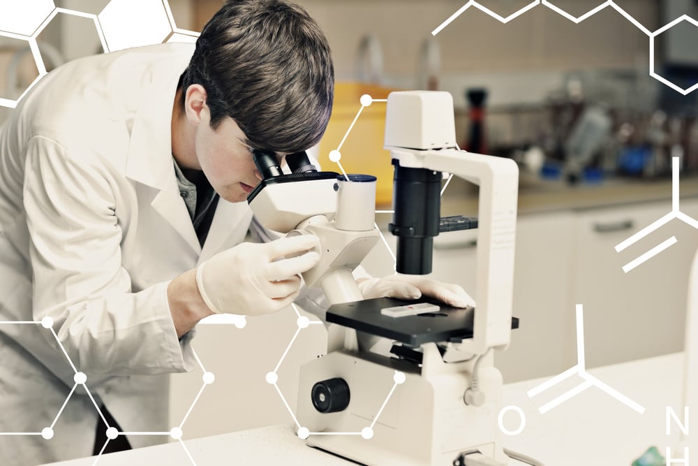 Science and medical graphic against science student looking in a microscope Science and medical graphic against science student looking in a microscope